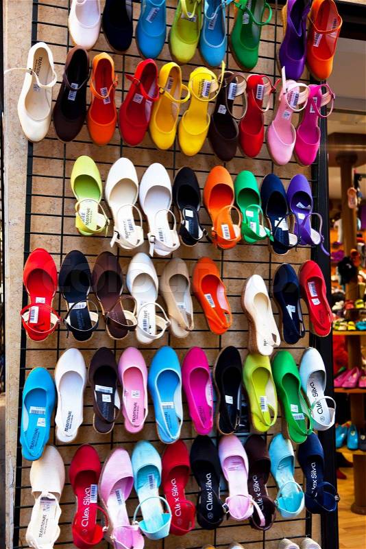 Many colorful shoes in the window of a shoe store, stock photo