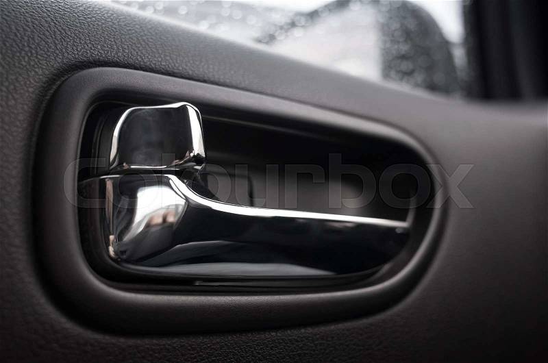 Inner door handle, modern car interior detail, stock photo