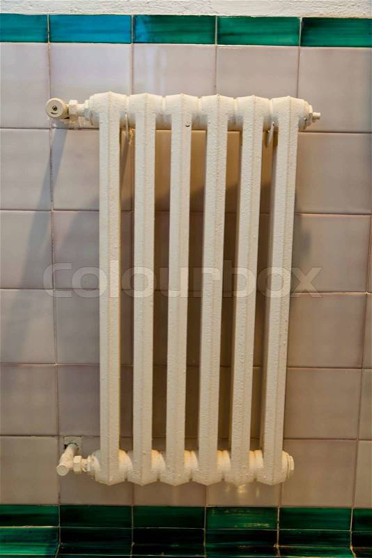 An old radiator to heat a home. Save energy, stock photo