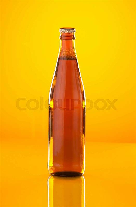 Beer bottle on yellow on yellow background, stock photo