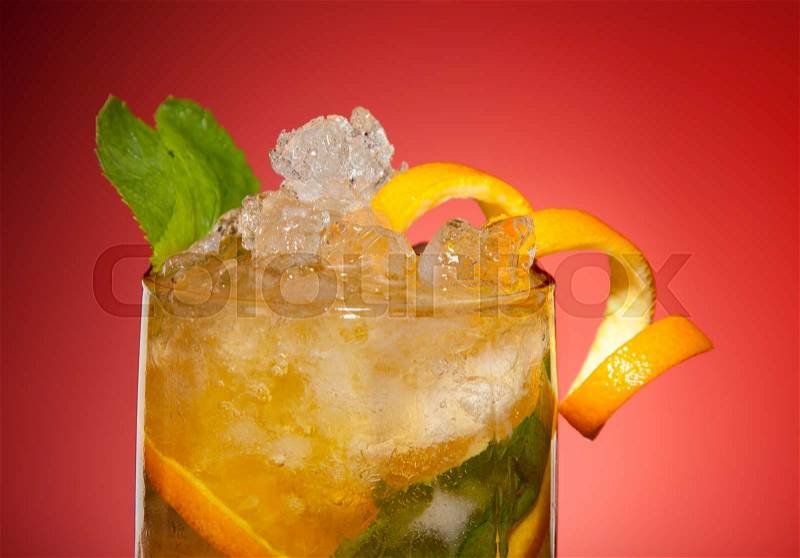 Fresh orange drink with ice, orange and mint in glass, stock photo