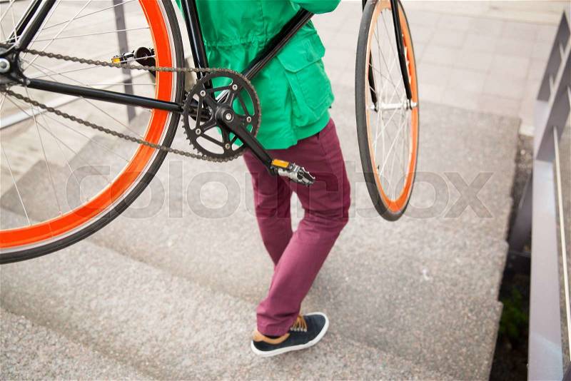 People, style, leisure and lifestyle - close up of man with fixed gear bike going downstairs, stock photo