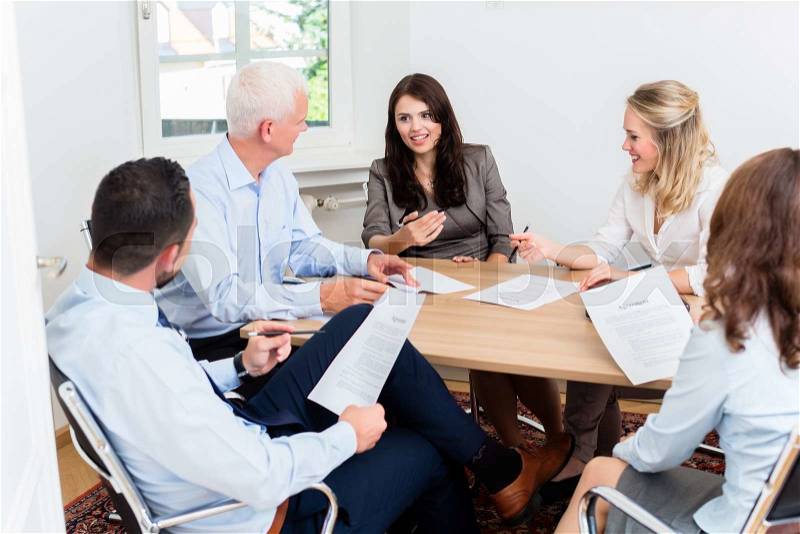 Lawyers having team meeting in law firm reading documents, stock photo