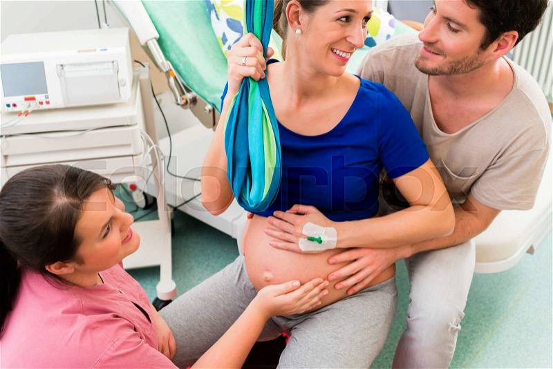 Pregnant woman preparing herself for giving birth, stock photo