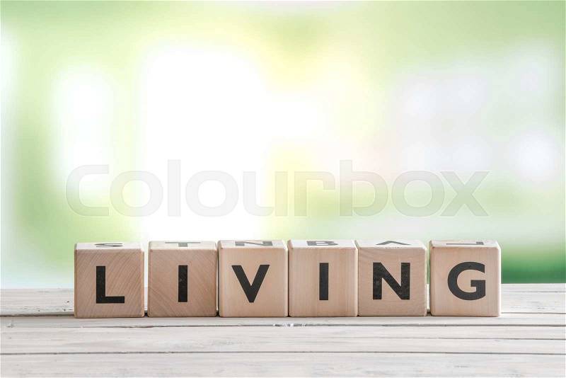 Living word on wooden cubes on a wooden table, stock photo