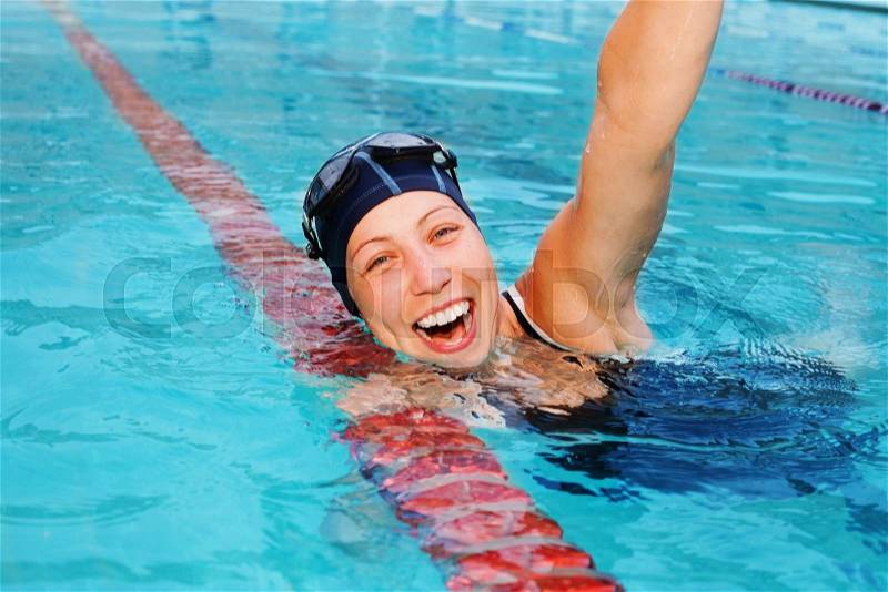 Nice girl professional swimmer is happy she won swimming contest, stock photo