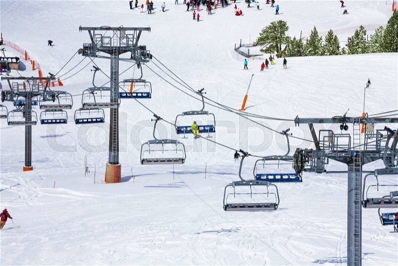 Ski lift and skiers on the background, stock photo