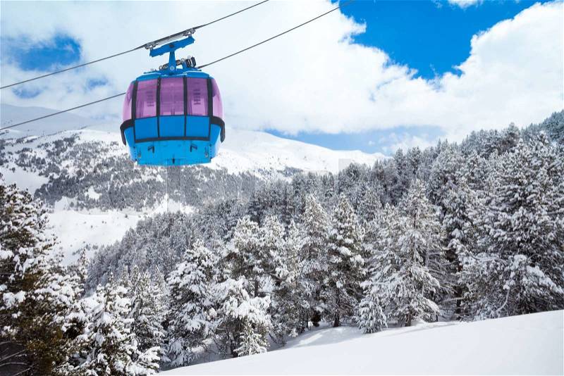 Closeup of ski lift cable car and forest covered with snow on the background, stock photo