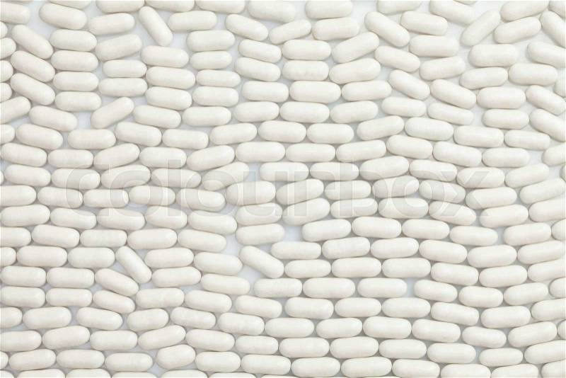 Many same white pills in a row pattern, stock photo