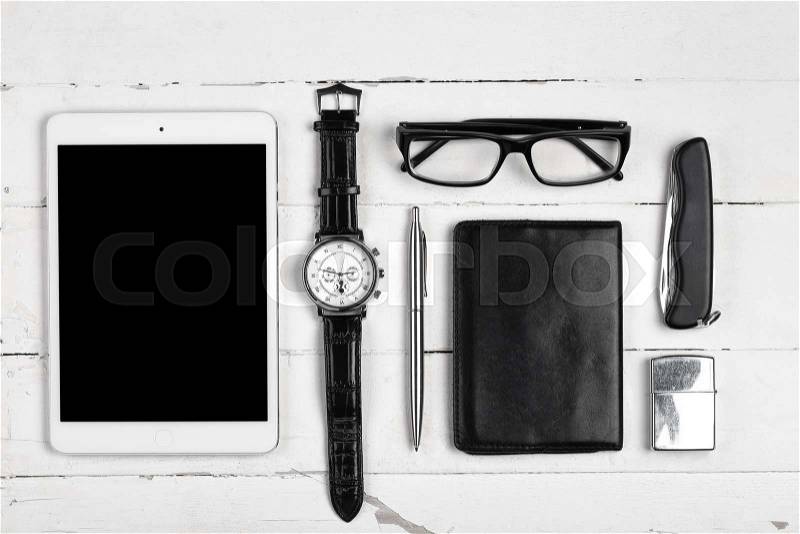 Business still-life with tablet computer glasses and cigarette lighter on white boards, stock photo