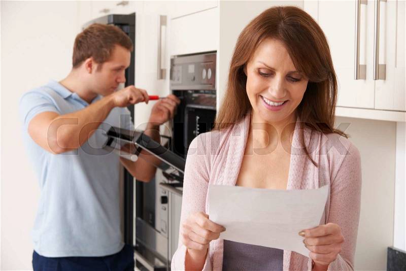 Smiling Woman With Repair Bill, stock photo