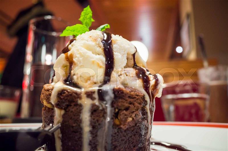 Molten chocolate cake with ice cream and mint leaf. Some other names used are chocolate fondant, chocolate moelleux or chocolate lava cake, stock photo