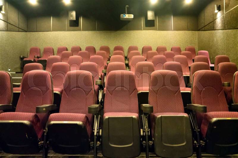Empty seats in the small movie theater with cinema projector, stock photo