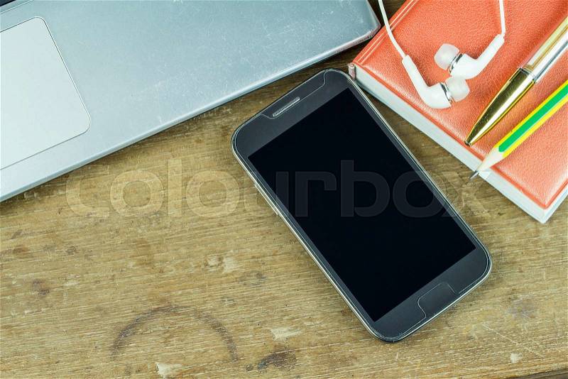 Office supplies and gadgets on a wooden table background, stock photo