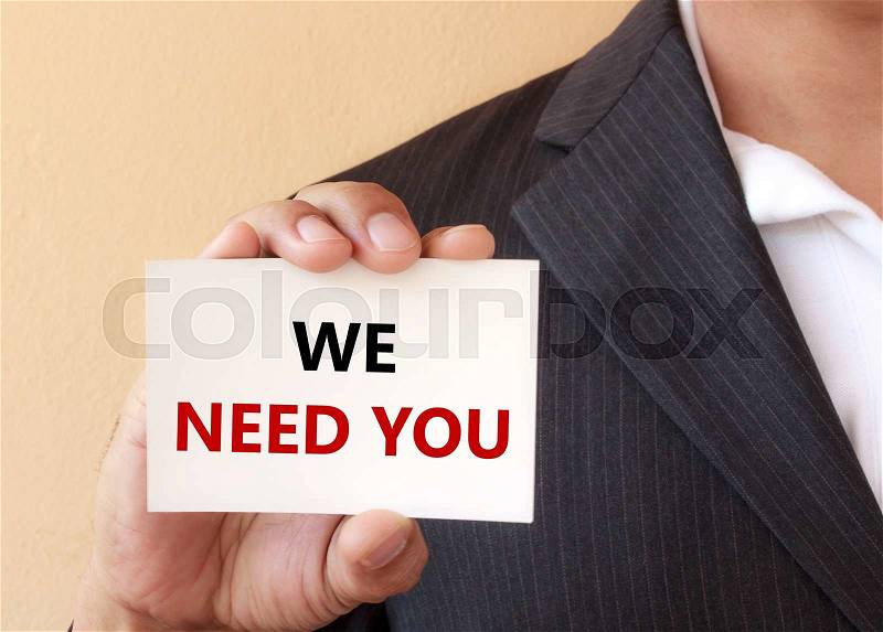 WE NEED YOU word on the white card shown by a businessman , stock photo