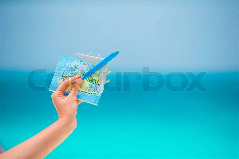 Closeup of map and toy airplane background the sea, stock photo