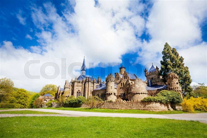 Spring meadow and Lion castle in Bergpark Lowenburg, Kassel Germany Europe, stock photo