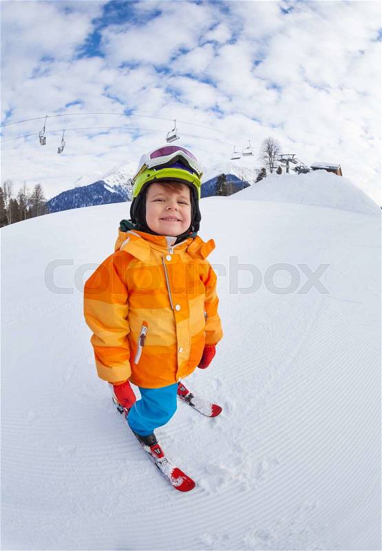 Cheerful boy wearing ski mask and helmet skiing on Sochi ski resort Krasnaya polyana in Russia, stock photo