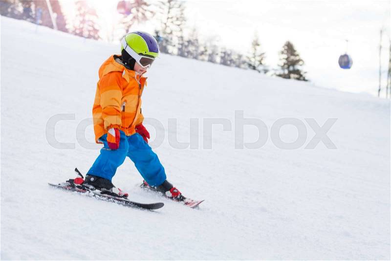 Skiing boy in ski mask and helmet on Sochi ski resort Krasnaya polyana in Russia, stock photo
