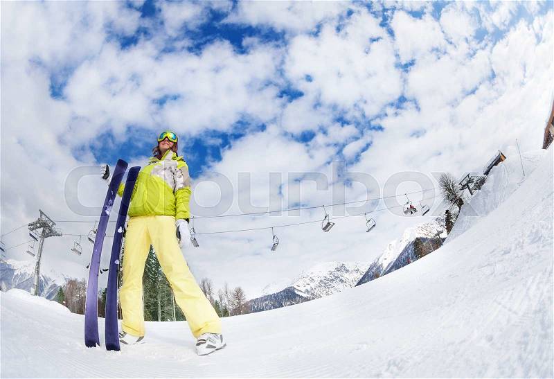 Young woman in mask standing and holding ski fisheye view during sunny winter day on Krasnaya polyana ski resort and Caucasus mountains in Sochi, Russia, stock photo