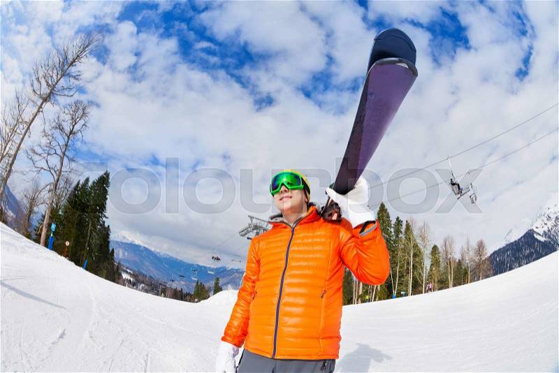 Happy young man wearing ski mask holds ski with beautiful mountain view on Sochi ski resort Krasnaya polyana in Russia, stock photo