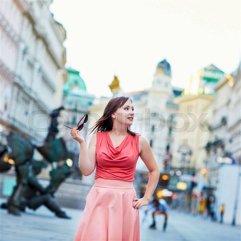 Beautiful young woman walking alone in Vienna, Austria, stock photo