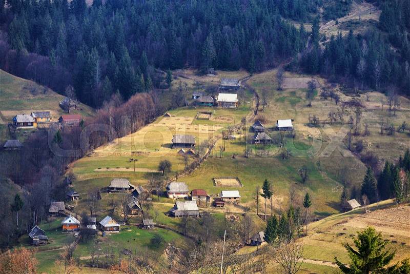 Sunny spring in mountain village. Carpathian fields and hills, stock photo