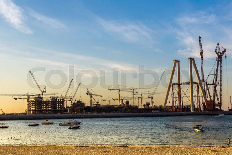 Construction site in Dubai at the sea sunset, stock photo