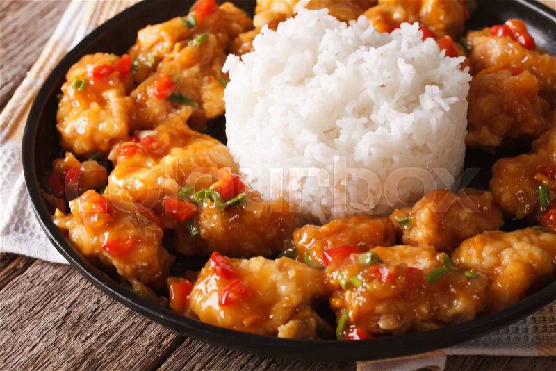 Orange chicken fillet with sauce and rice closeup on a plate. horizontal , stock photo
