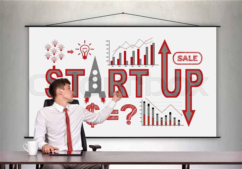 Businessman showing a business start up concept on poster, stock photo