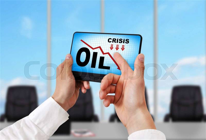 Hand holding digital tablet pc with oil crisis chart, stock photo