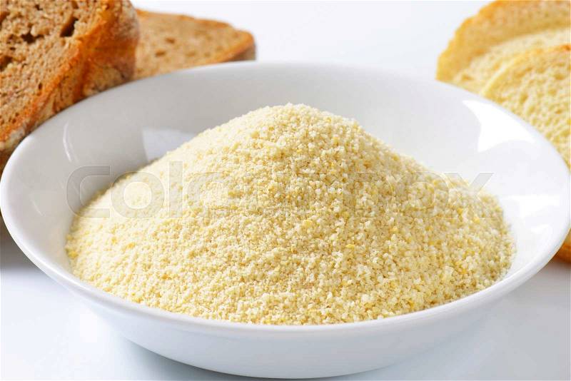 Pieces of stale bread and pile of finely ground bread crumbs, stock photo