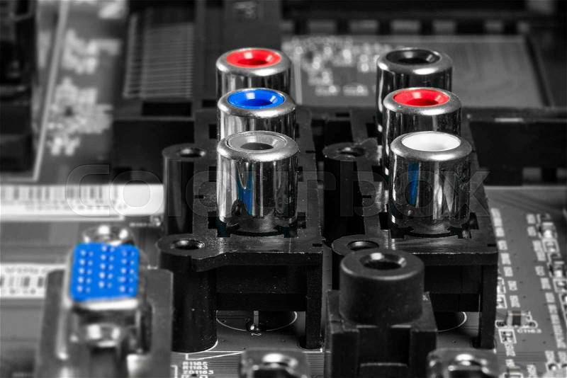 Audio item on a motherboard in red and blue, stock photo