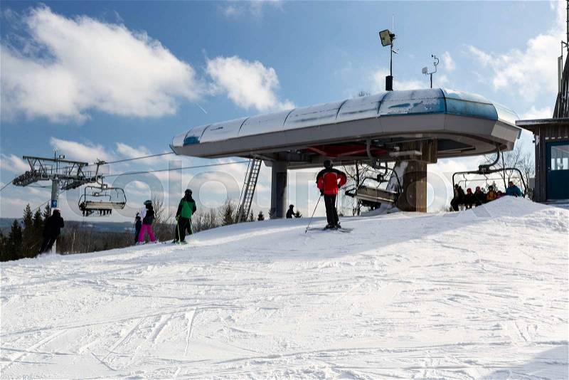 ISABERG, SWEDEN - FEBRUARY 17, 2016: Top station of modern chair lift at the small ski resort Isaberg in Sweden welcomes skiers on a sunny day during the main skiing season in February, stock photo