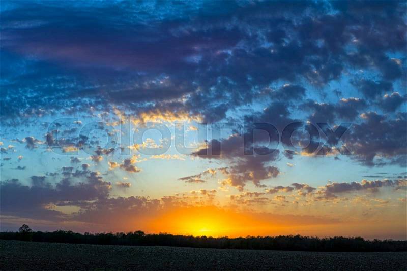The sun set under a cloudy sky in the American Midwest, stock photo
