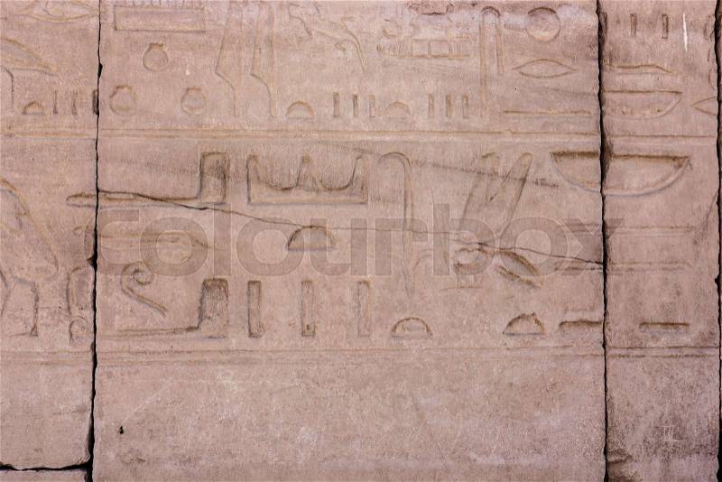 Egyptian hieroglyphs. Hieroglyphic carvings on a wall, stock photo