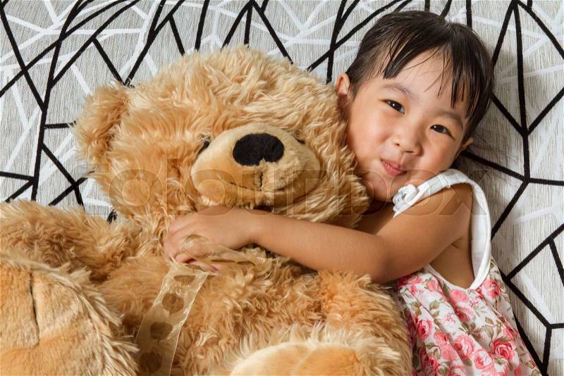 Asian Little Chinese Girl with Teddy Bear at Home, stock photo