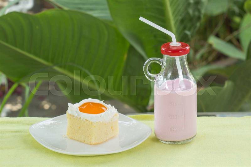 Mini cake with Orange jam topping with strawberry Flavour milk, stock photo