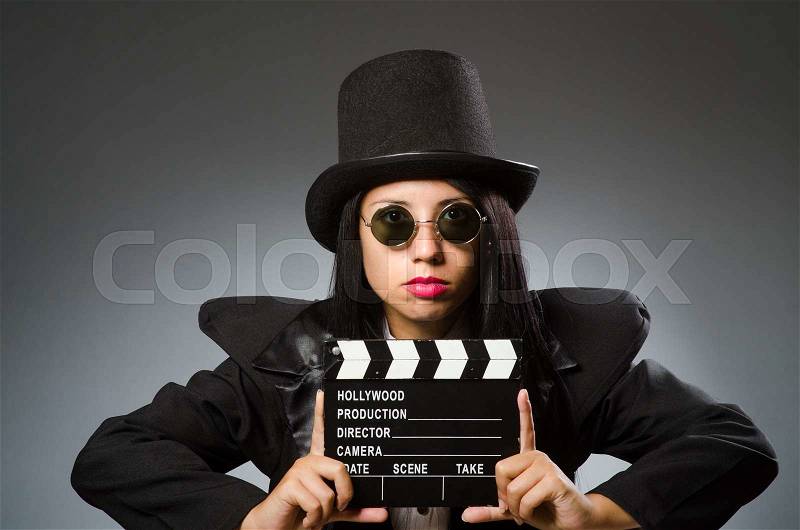 Woman with vintage hat and movie board, stock photo