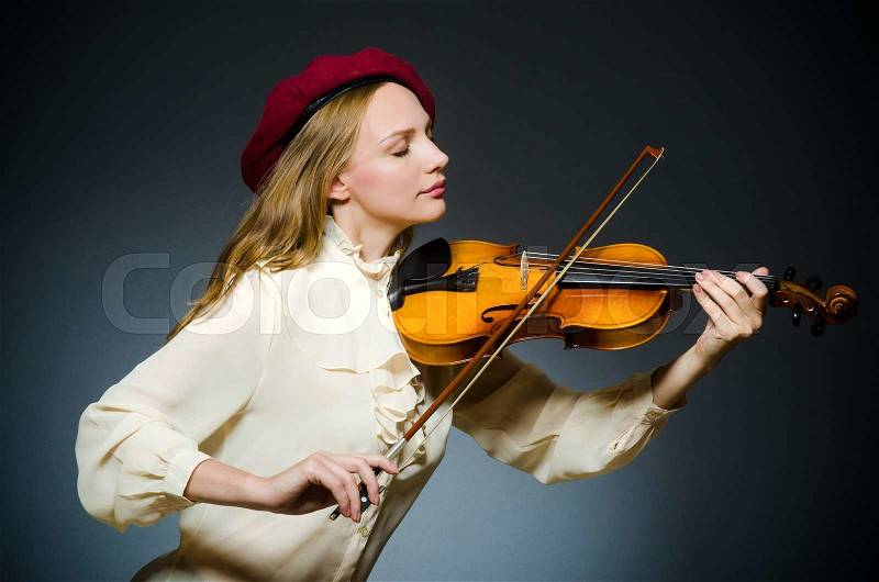 Woman violin player in musical concept, stock photo