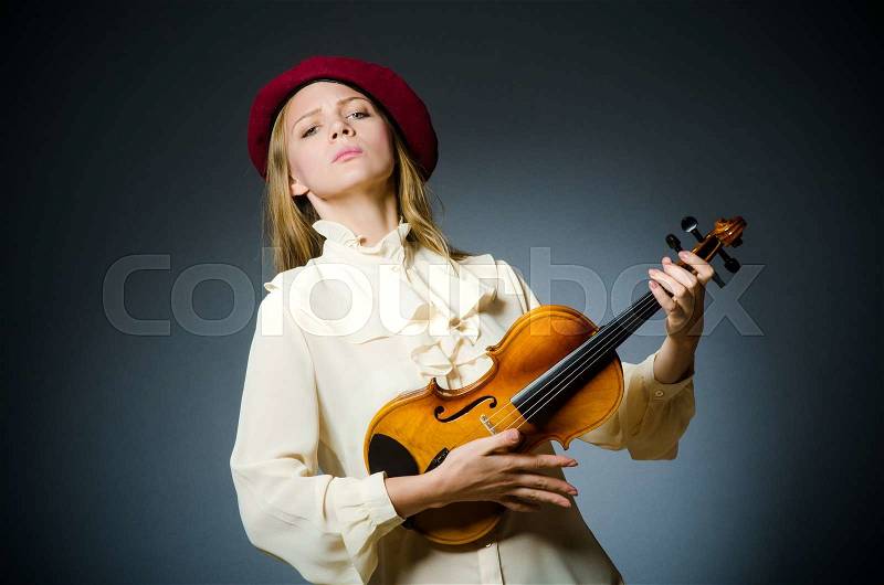 Woman violin player in musical concept, stock photo