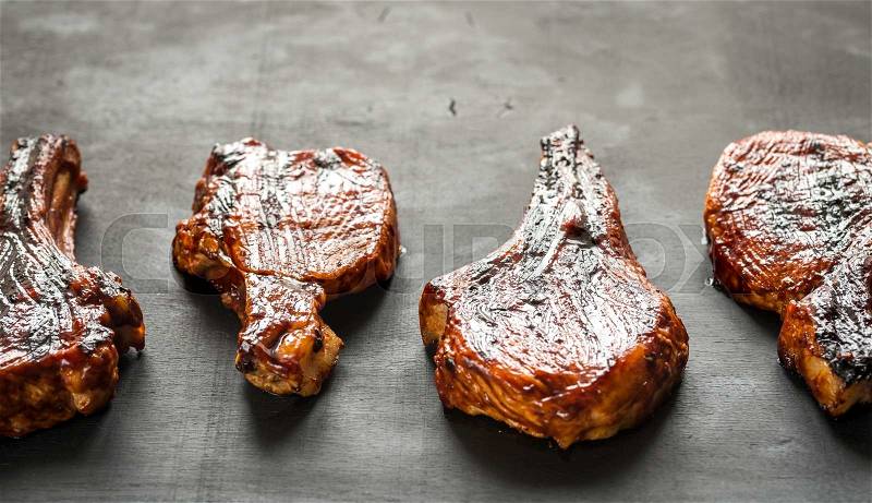 Grilled pork ribs on the wooden background, stock photo