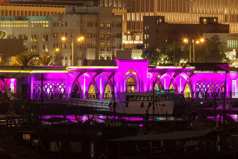 Doha city purple waterfront building illuminated at night. Qatar, Middle East, stock photo
