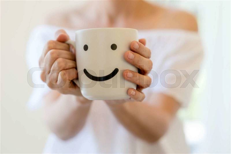 Woman hands holding a white coffee mug, stock photo