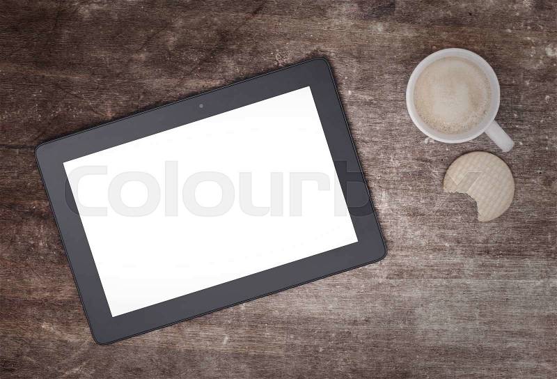 Tablet touch computer gadget on wooden table, vintage look, stock photo