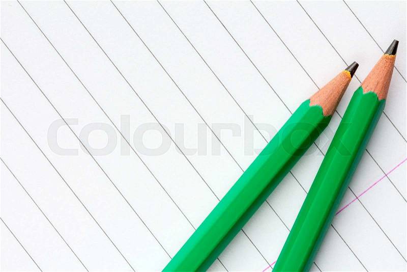 Two Green Pencils on Traditional Lined Paper for School, stock photo