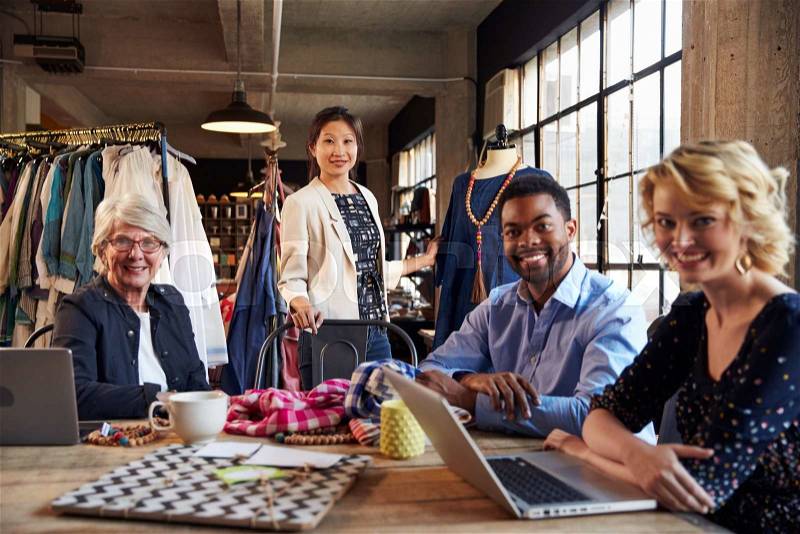 Portrait Of Four Fashion Designers In Meeting, stock photo