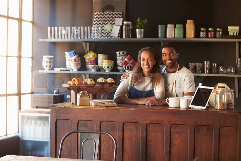 Portrait Of Couple Running Coffee Shop Behind Counter, stock photo