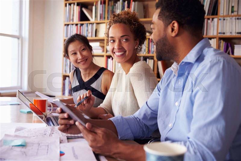 Business Team Having Meeting In Busy Office, stock photo