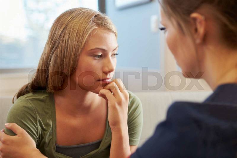 Nurse Treating Teenage Girl Suffering With Depression, stock photo